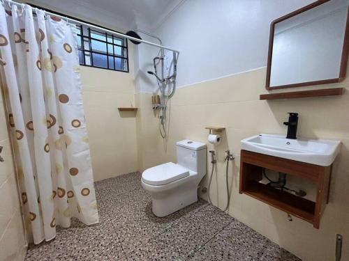 a bathroom with a toilet and a sink at Home of Camper 659 in Seremban (16-18Pax) in Seremban