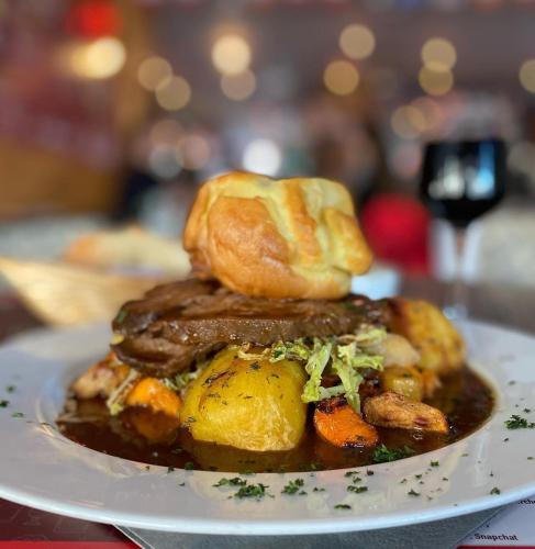 a plate of food with meat and bread on it at Hotel Rhodos Morzine in Morzine