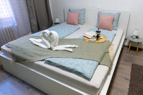 a bed with towels and pillows on it at Wanderer 3 in Debrecen