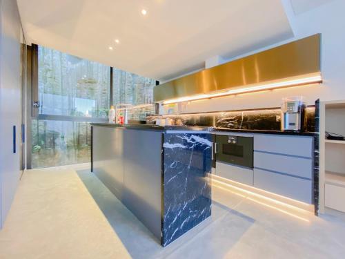 a kitchen with a counter with a blue counter top at Pyrmont Town House Homestay in Sydney