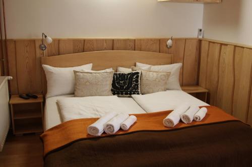 a bed with three slippers on top of it at Tiszafa Vendégház Szentgál in Szentgál
