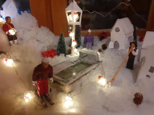 a model of a house with people in the snow at Le Saint Vincent in Apremont