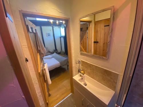 a bathroom with a sink and a mirror at Windsor/Ascot/Bracknell beautiful barn in Bracknell