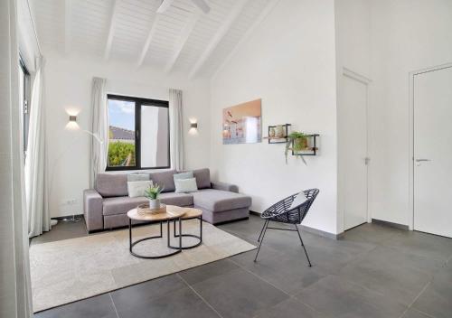 a living room with a couch and a table at Grand Windsock Bonaire in Kralendijk