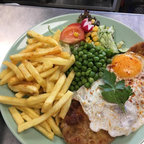 a plate of food with a fried egg and french fries at Lindenhof Liepgarten - Pension & Gaststätte in Ueckermünde