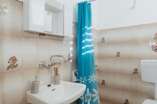 a bathroom with a sink and a shower at Stella Studios in Argasi