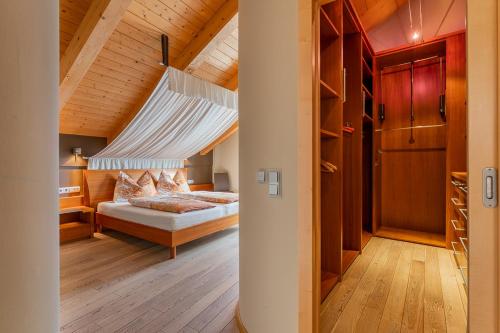 a bedroom with a bed with a canopy at Ski Dome Apartments & Heaven Holiday Chalet in Kaprun