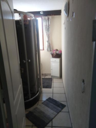 a bathroom with a shower and a tiled floor at Mouhet Appartement Sortie 21 A20 in Mouhet