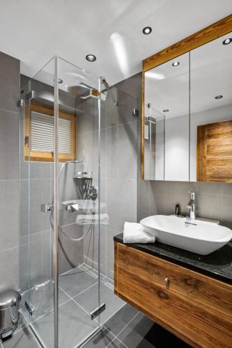 a bathroom with a sink and a shower at Chalet Larchwood by Mrs Miggins in Grimentz