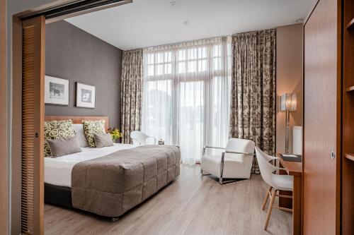 Postel nebo postele na pokoji v ubytování Hotel De Pupiter