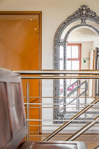 a mirror on a wall next to a stairway at Hotel De Pupiter in Kluisbergen