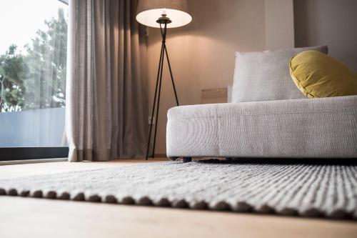 a living room with a couch and a lamp at OVINA`s HAUS in Sand in Taufers