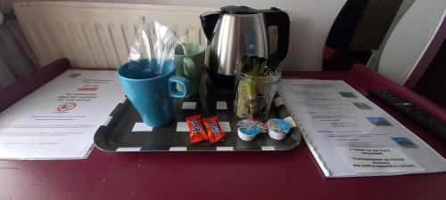 a tray with cups and utensils on a table at Le Saint Vincent in Apremont