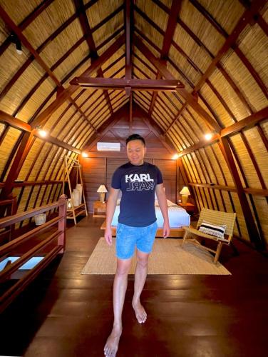 a man standing in the middle of a room at Bhumi Lovina Residence & Villa in Singaraja