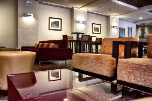 a living room with couches and chairs and tables at Don Paco in Llanes