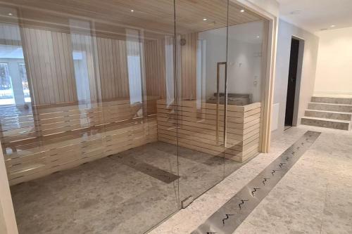 a bathroom with a glass shower in a building at Charming apartment pool, SPA, sauna, CIR VDA - AYAS - 0005- in Champoluc