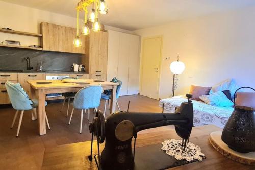 a kitchen and living room with a sewing machine on the floor at Charming apartment pool, SPA, sauna, CIR VDA - AYAS - 0005- in Champoluc