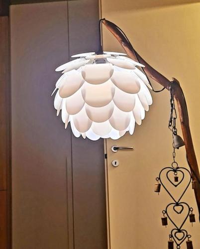 a white light hanging from a door with a heart lamp at Charming apartment pool, SPA, sauna, CIR VDA - AYAS - 0005- in Champoluc