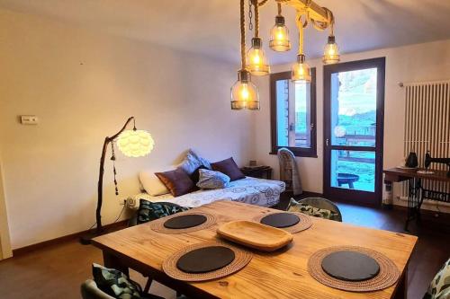 a living room with a wooden table and a couch at Luxury apartment with pool, sauna, SPA in Champoluc