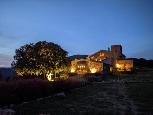 a house lit up at night with lights at Mas Oms in Montnegre