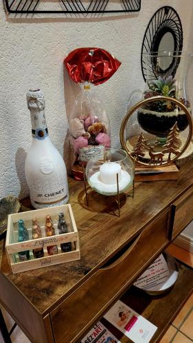 a table with a vase and other items on it at Gîte au cœur des vignes avec piscine et spa in Saudoy