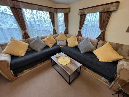 a living room with a couch and a table at Summer Dreams Holiday Home in Skegness