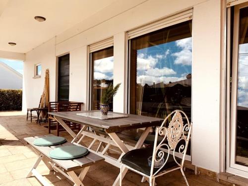 a wooden table and chairs on a patio at Charming House in SINTRA with Private Pool in Sintra