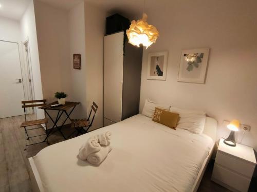 a bedroom with a bed with a towel on it at Pequeño Alojamiento con Mini Piscina - NO climatizada in Valencia