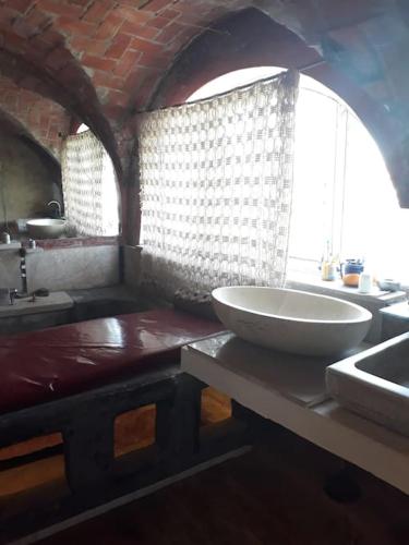 a bathroom with a large white sink and a tub at la casbah in Hammamet