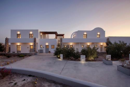 a large white house with a driveway at New Villa Katerina Collection in Megalokhori