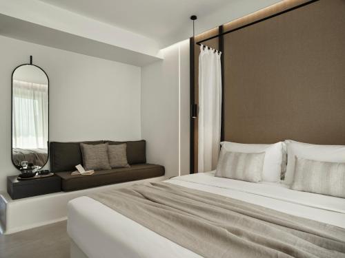 a bedroom with a large bed and a couch at Ezio Bo Luxury Living in Mýkonos City
