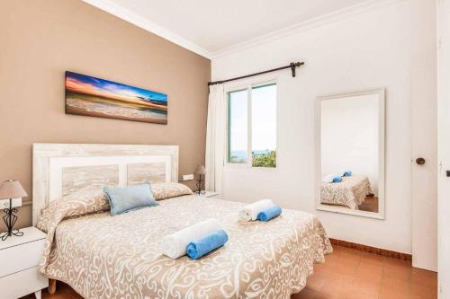 a bedroom with a bed with two pillows on it at Vista Arenal in Arenal d'en Castell