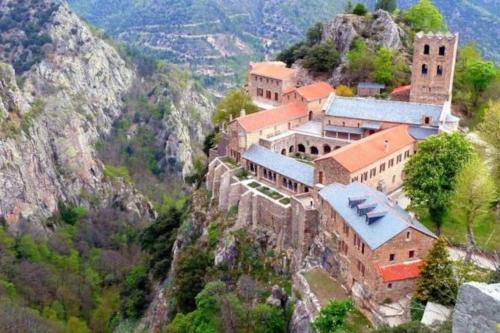 a building on the side of a mountain at Appartement l'Insolite in Vernet-les-Bains