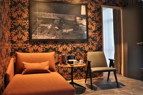 a living room with a couch and a table and a chair at Hotel Brandan in Tórshavn