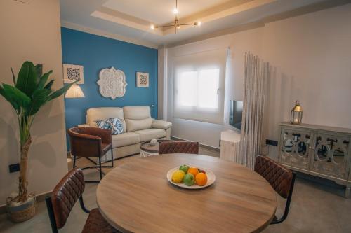 a living room with a table with fruit on it at Apartamentos Turísticos La Baílla in Rota