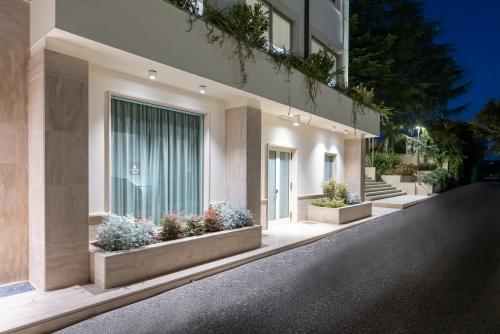 a building with potted plants on the side of it at Mirabella Hotel in Mirabella Eclano