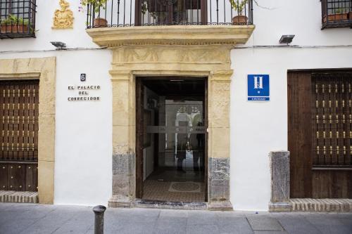 a building with a sign on the side of it at Hostal Palacio del Corregidor in Córdoba