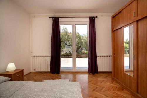 a bedroom with a bed and a large window at Apartment in Rovinj/Istrien 11487 in Štanga