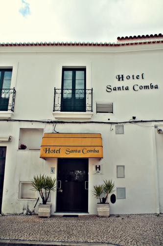 a hotel santa comedia building with a door and plants at Hotel Santa Comba in Moura