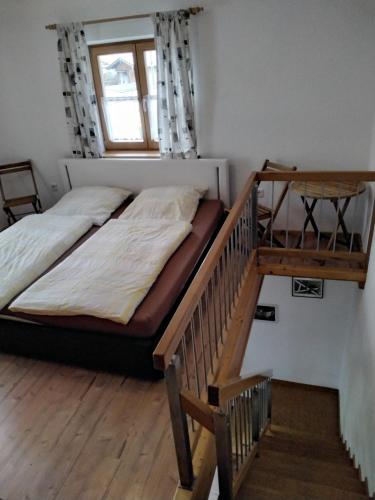 a bedroom with a bunk bed and a staircase at Ferienwohnung Maxl in Fischbachau