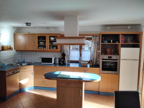 a kitchen with wooden cabinets and a blue counter top at Ferienwohnung Maxl in Fischbachau