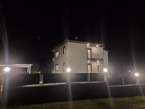 a building with lights in front of it at night at Kashmir Luxury Apartments in Neos Marmaras