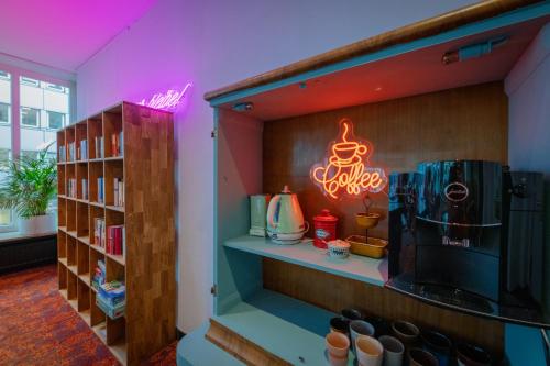a room with a shelf with a coffee maker on it at Hessenland Hotel Kassel Innenstadt by Stay Awesome in Kassel