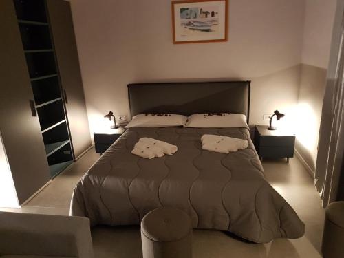a bedroom with a large bed with two pillows at Your Home in Naples in Naples