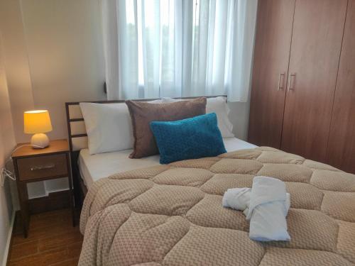 a bedroom with a large bed with two pillows at Kashmir Luxury Apartments in Neos Marmaras