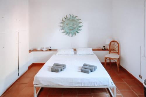 a bedroom with a bed with two pillows on it at Casa di Giò in Pula