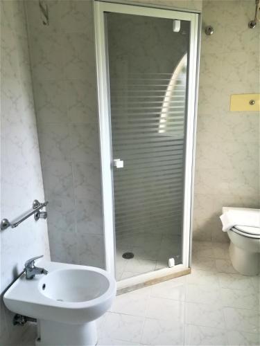 a bathroom with a shower and a sink and a toilet at Casa Malo' in Ischia