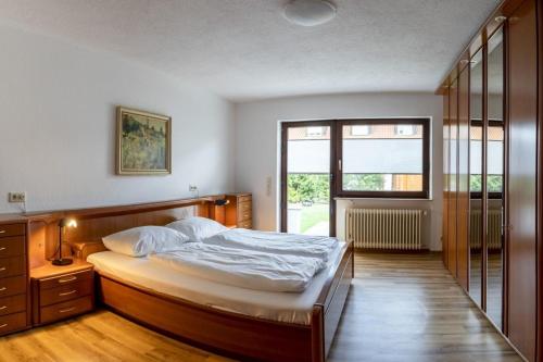 a bedroom with a bed and a window at Ferienhaus Wila in Wyhl