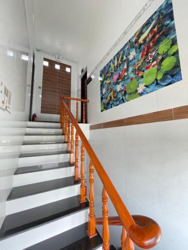 a staircase in a house with a painting on the wall at Nhà nghỉ Quỳnh Như in Cao Lãnh