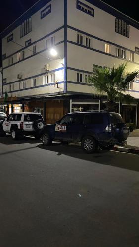 two police vehicles parked in front of a building at Hotel Dubai in Tan-Tan Plage